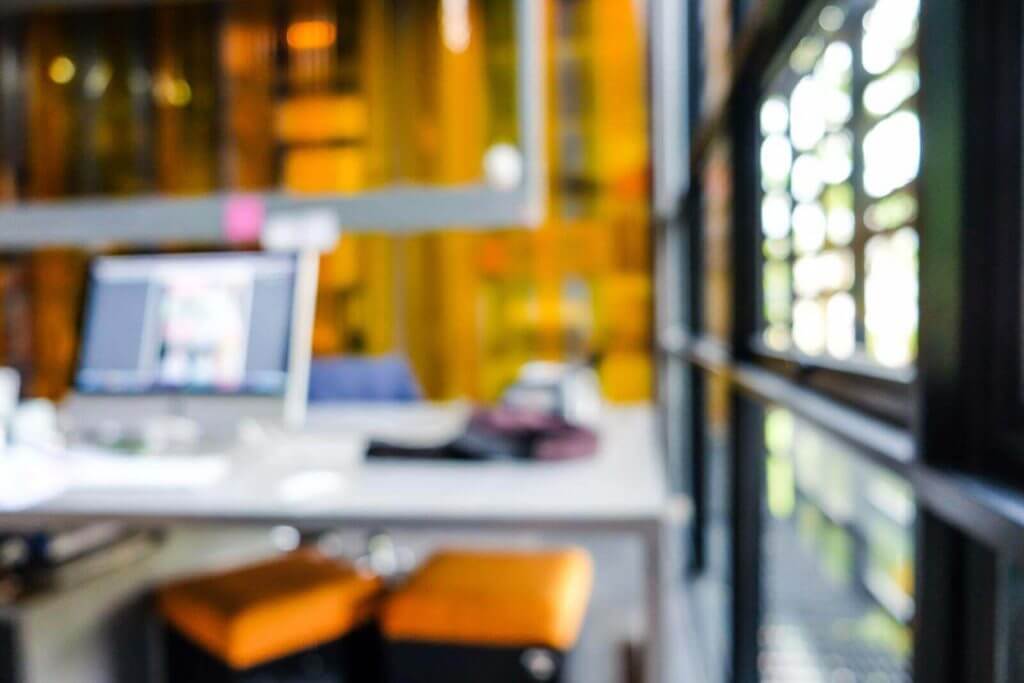 A blurry image of a desk in an office.