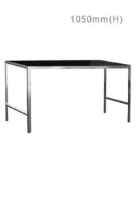 A Barcelona Long Bar Table with a black glass top and metal legs.