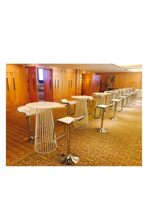 a group of replica birdcage bar tables and chairs in a conference room
