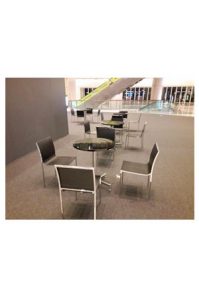 a group of aura black chairs and tables in a lobby