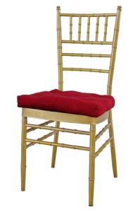 a gold tiffany chair with red cushion