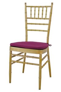 a gold tiffany chair with purple cushion