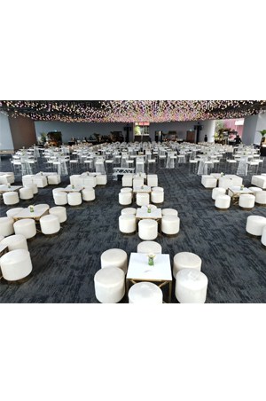 a large room filled with hudson square ottomans tables and chairs