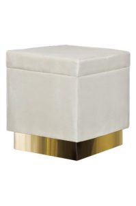 a hudson square ottoman with a gold base