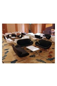 A group of black and white Replica Swan Sofa - Double Seaters in a conference room.