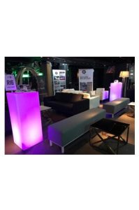 an illuminated plinth bistro set with purple lighting and couches