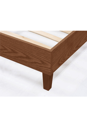 a close up of the oaksford queen bed walnut