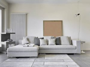 a living room with a grey couch and a white rug