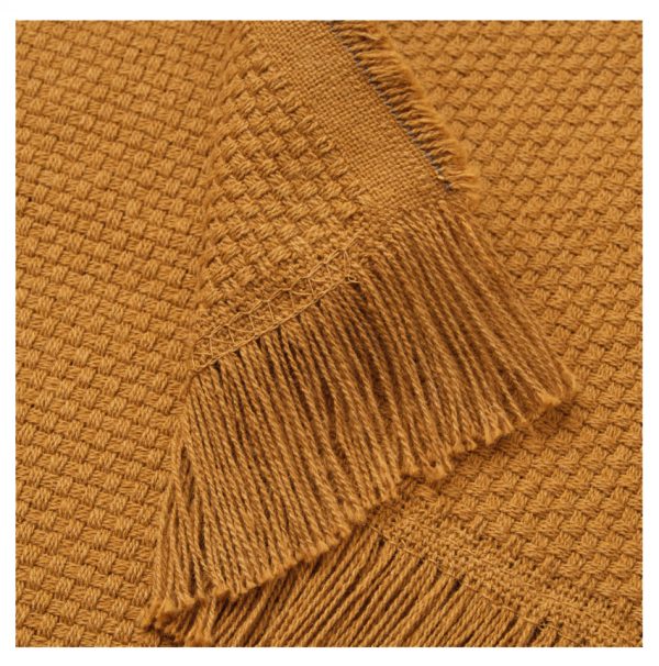 A close up of a Throw In Dark Golden Brown blanket with fringes.