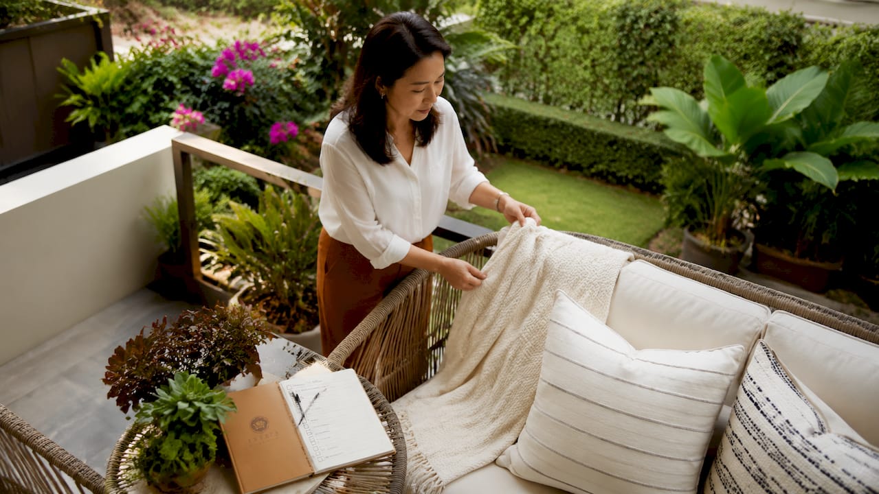Home stager arranging furniture in luxury landed home