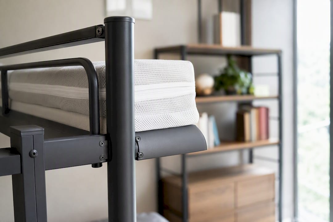 Close-up steel bunk bed and mattress cover