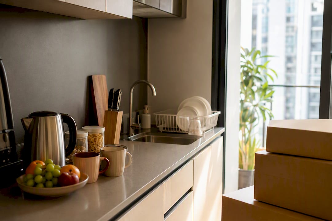 Partially unpacked kitchen in temporary rental apartment