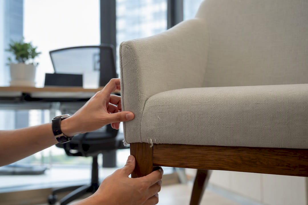 Hands photographing furniture corner in condo dining room
