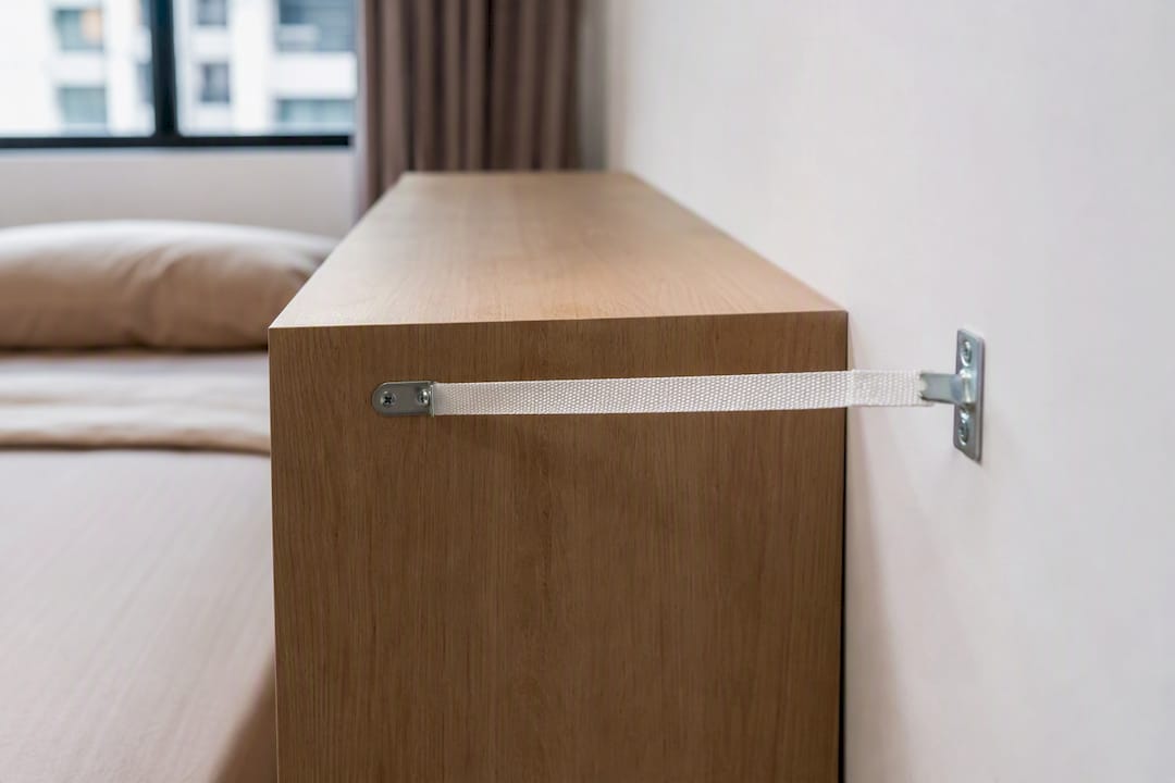 Anti-tip strap securing bedroom storage