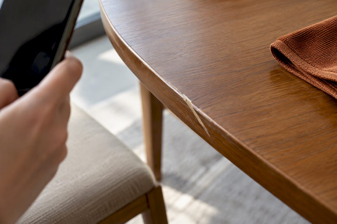 Scratch being documented on dining tabletop